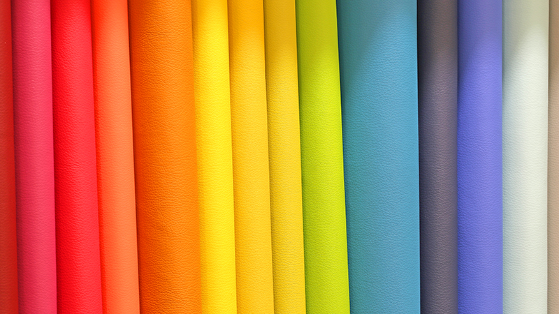 Colorful fabrics of many bright and vivid colors for sale in the shop specialized in fabrics for the processing of clothes