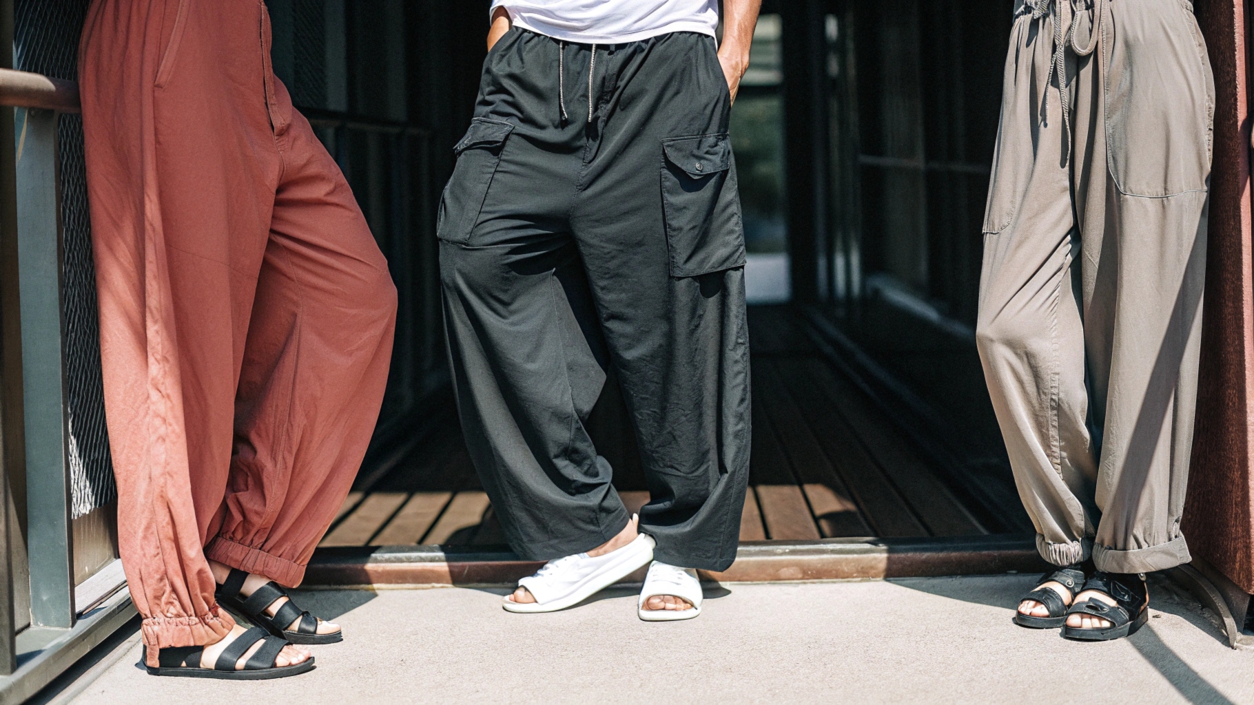 Three styles of baggy pants displayed: wide-leg paired with a casual T-shirt and sandals, jogger-style with cuffed ankles and sneakers, and high-waisted with a tucked-in blouse and heels.