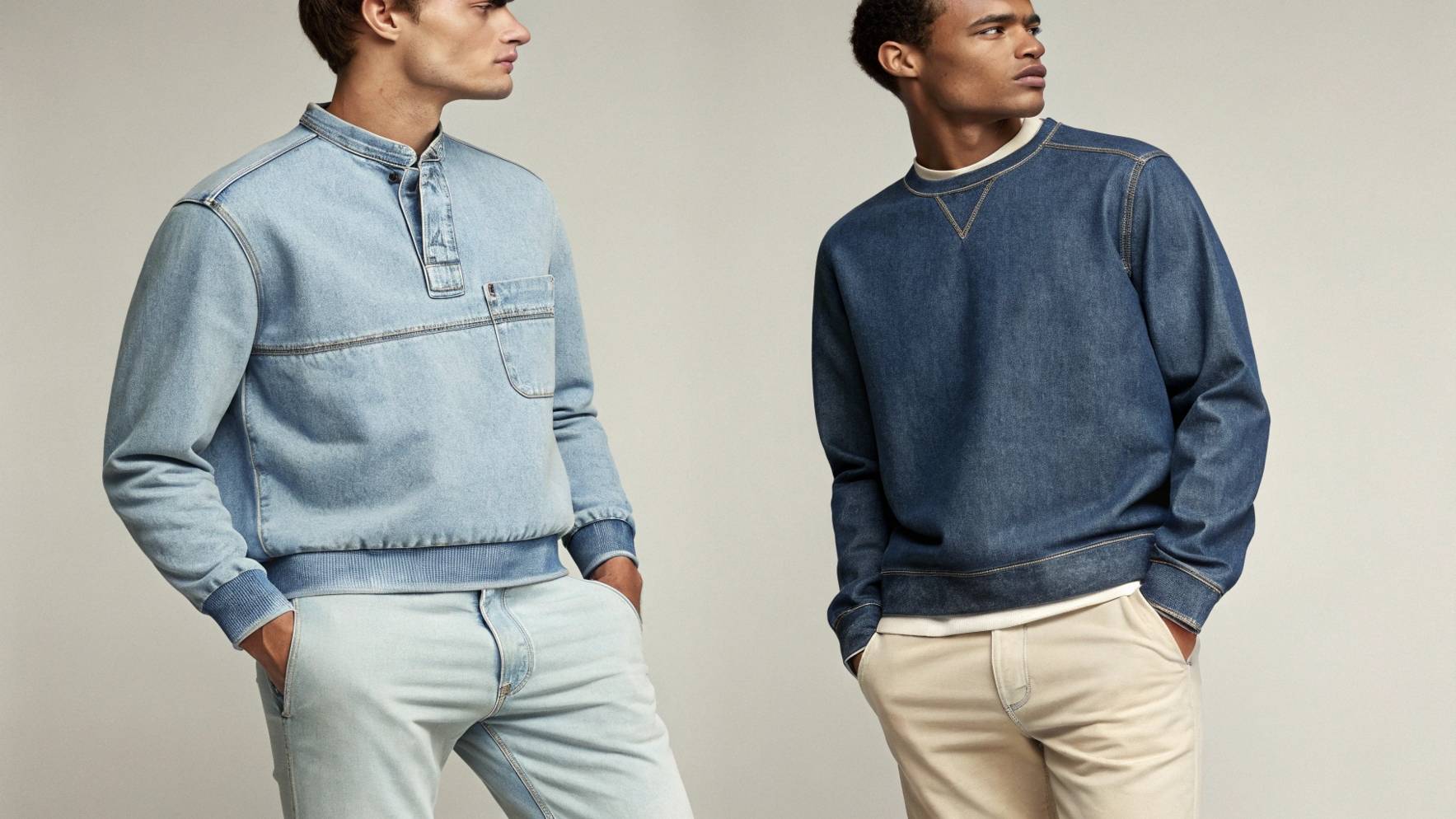 Two models wearing denim sweatshirts—one paired with light jeans for a relaxed look, and the other with chinos for a more polished style, showcasing the sweatshirt's versatility for different casual outfits.