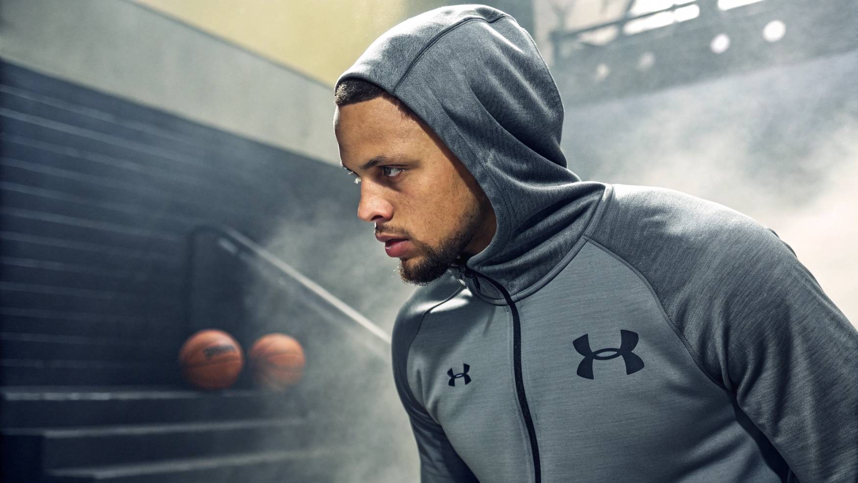 An athlete wearing a modern sweatshirt inspired by Under Armour's ColdGear® and UA Tech™, showcasing moisture-wicking fabrics and thermal protection for intense workouts, with sleek design and advanced materials for performance and comfort.