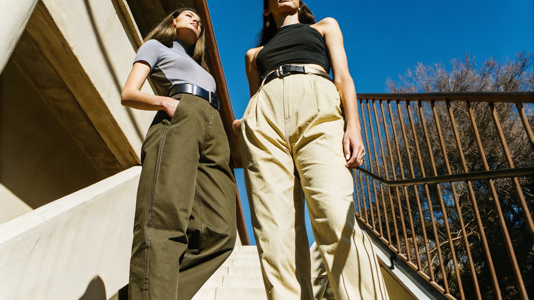 Baggy pants styled with a slim T-shirt, belt for structure, and a crop top variation, balancing oversized and sleek elements.
