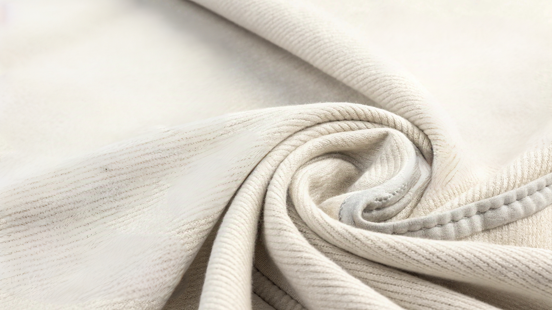 Close-up showcase of Kith’s high-quality fabrics like organic cotton, French terry, and heavyweight fleece, highlighting texture, stitching, and sustainable sourcing in a luxurious fashion studio setting.