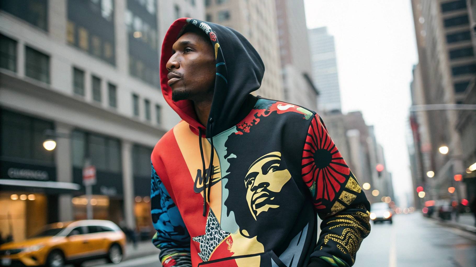 Celebrity wearing a graphic hoodie with bold artwork or album cover design, set in an urban environment, reflecting the influence of pop culture, music, and iconic artwork in modern fashion.